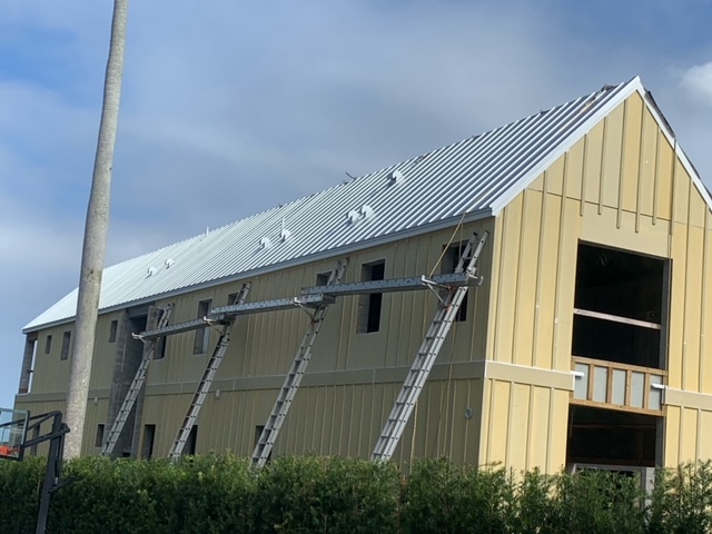 https://bluevisionroofing.com/wp-content/uploads/2025/07/Blue-Vision_Our-Work_Yellow-Structure.jpeg