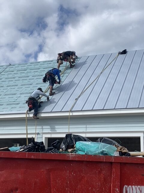 wp-content/uploads/2025/09/Blue-Vision_Our-Work_Metal-Roof-with-Staff-rotated.jpeg